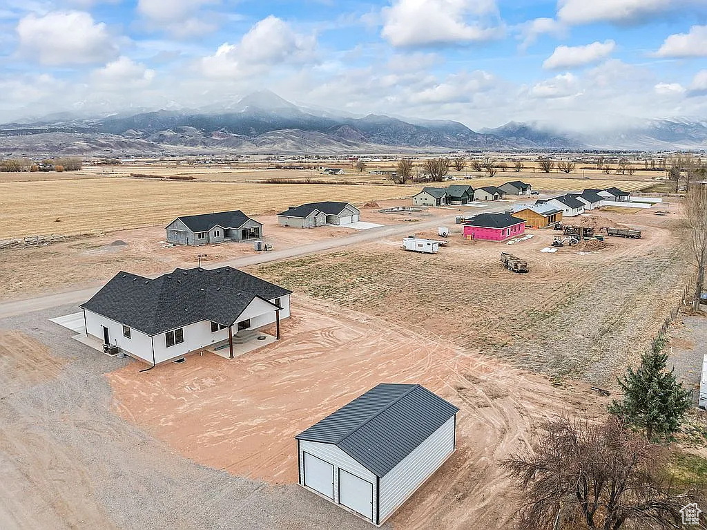 Aerial view of sparsely populated area with a mountain backdrop