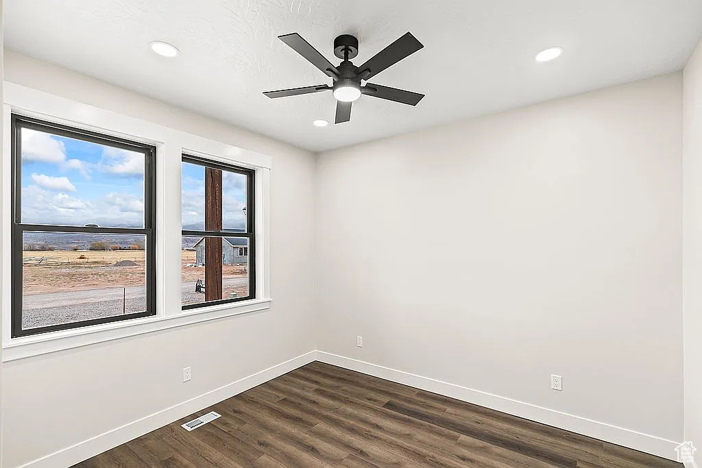 Unfurnished room with baseboards, dark wood finished floors, ceiling fan, and recessed lighting
