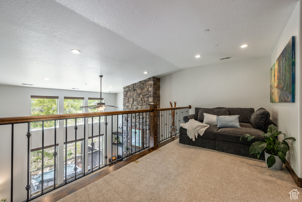 Sitting room with ceiling fan, a textured ceiling, recessed lighting, and carpet