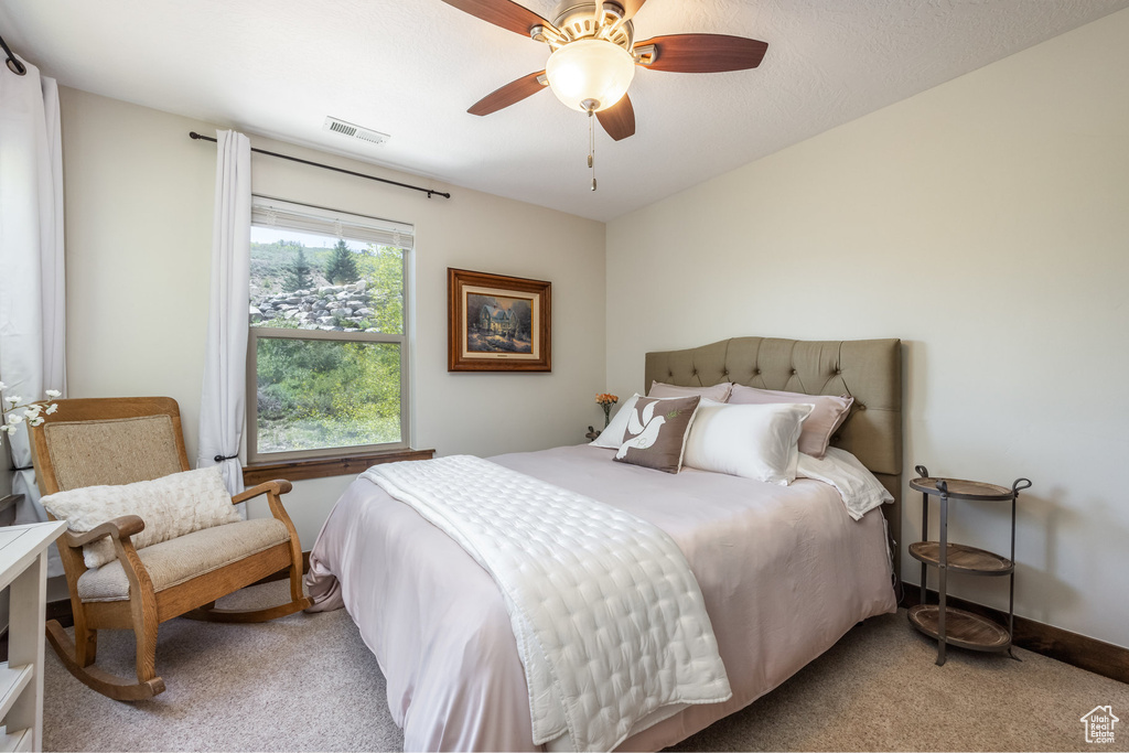 Bedroom featuring carpet, a ceiling fan, and baseboards