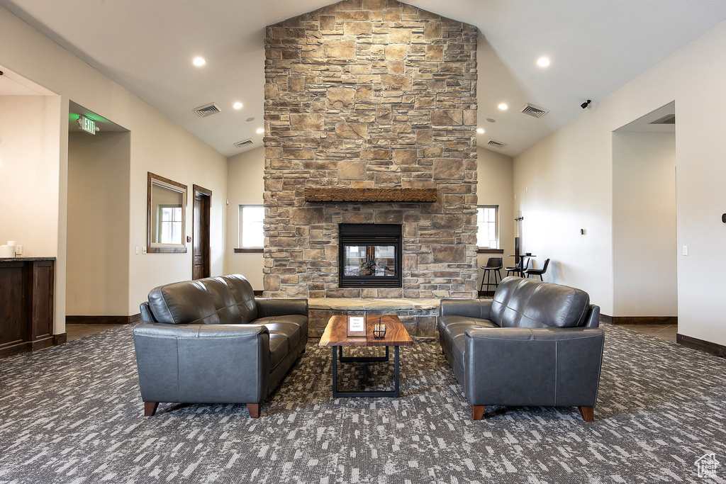 Living area featuring high vaulted ceiling, a fireplace, recessed lighting, and baseboards