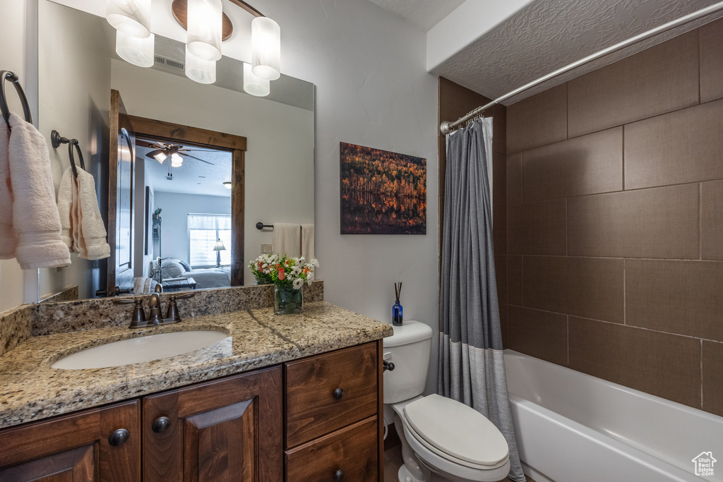 Ensuite bathroom with toilet, vanity, and shower / bath combination with curtain