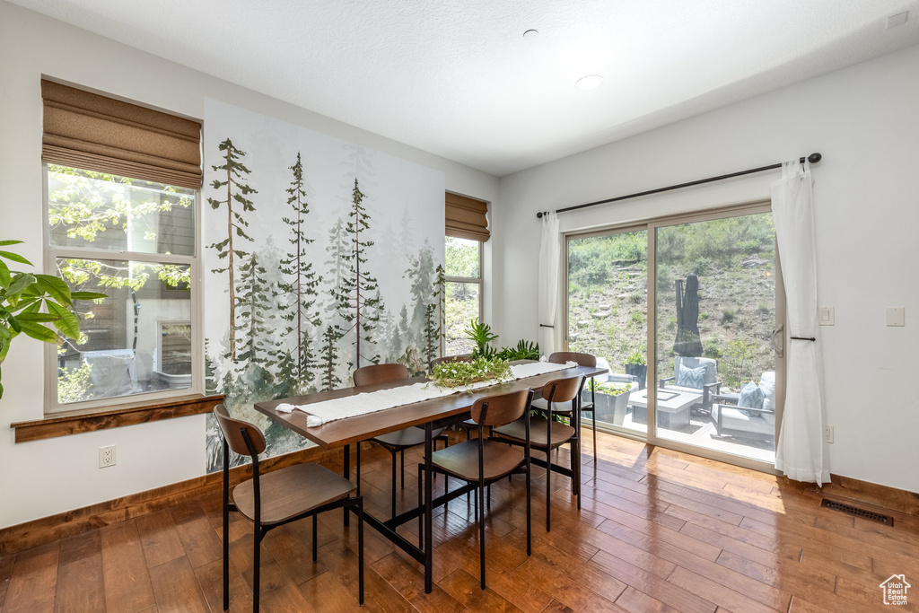 Dining space featuring hardwood / wood-style floors and baseboards