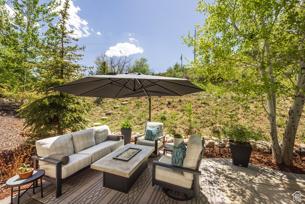Wooden terrace with an outdoor living space with a fire pit and a patio area