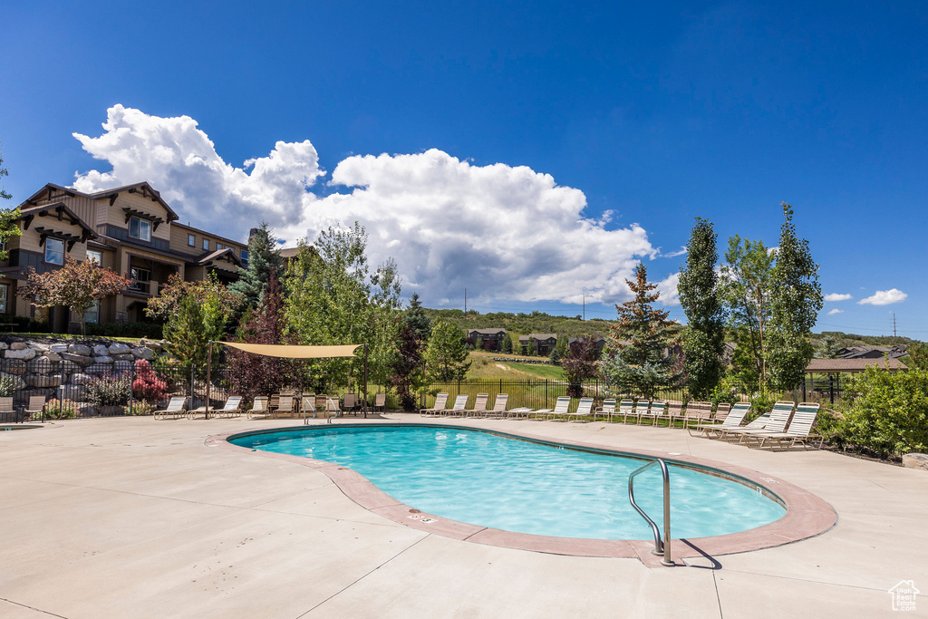 Community pool featuring a patio