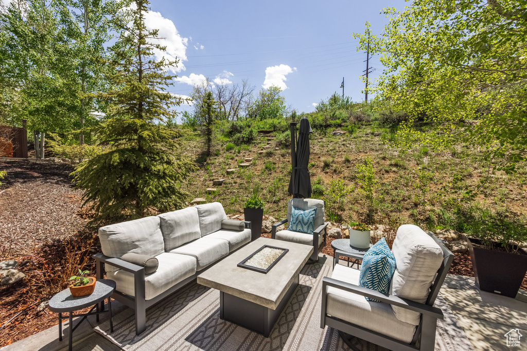 Deck with outdoor lounge area and a patio area