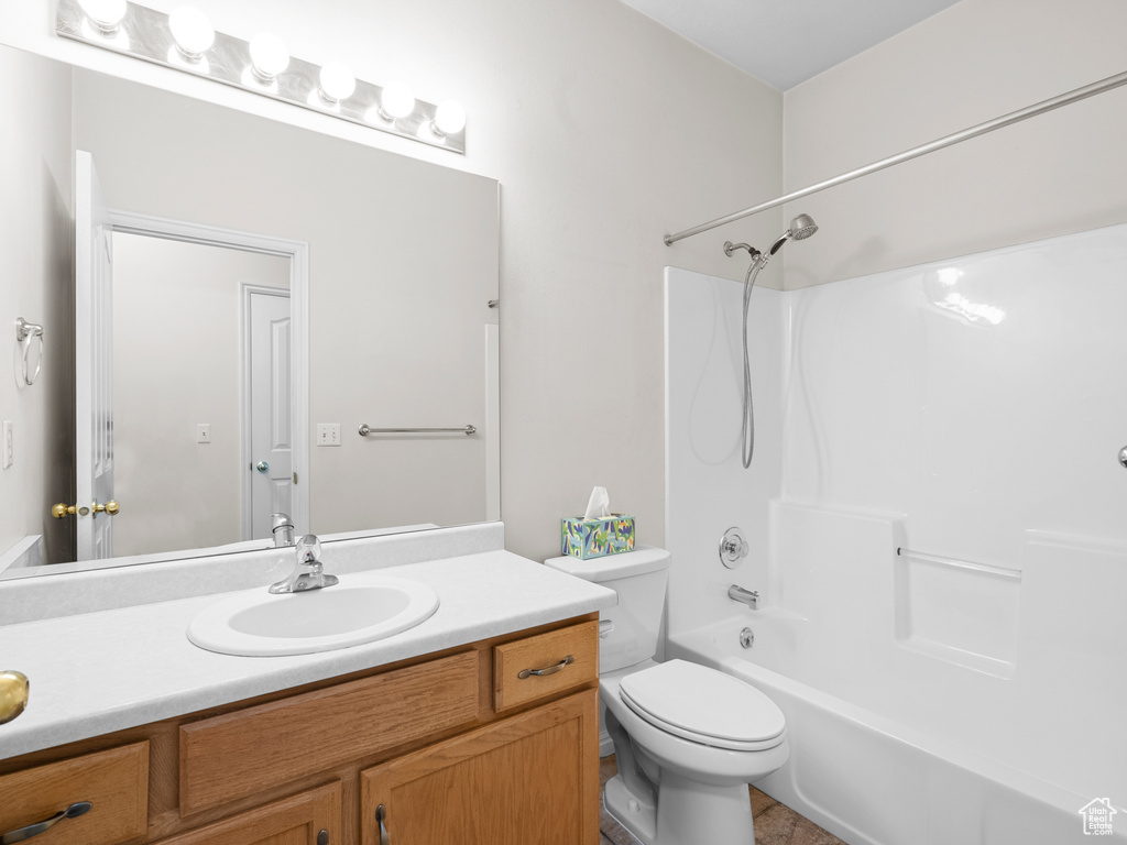 Full bathroom with vanity, toilet, and washtub / shower combination