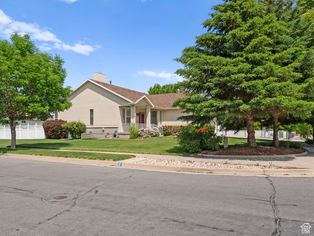 Single story home with stucco siding and a chimney