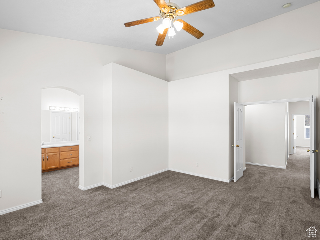 Spare room with carpet flooring, ceiling fan, and baseboards