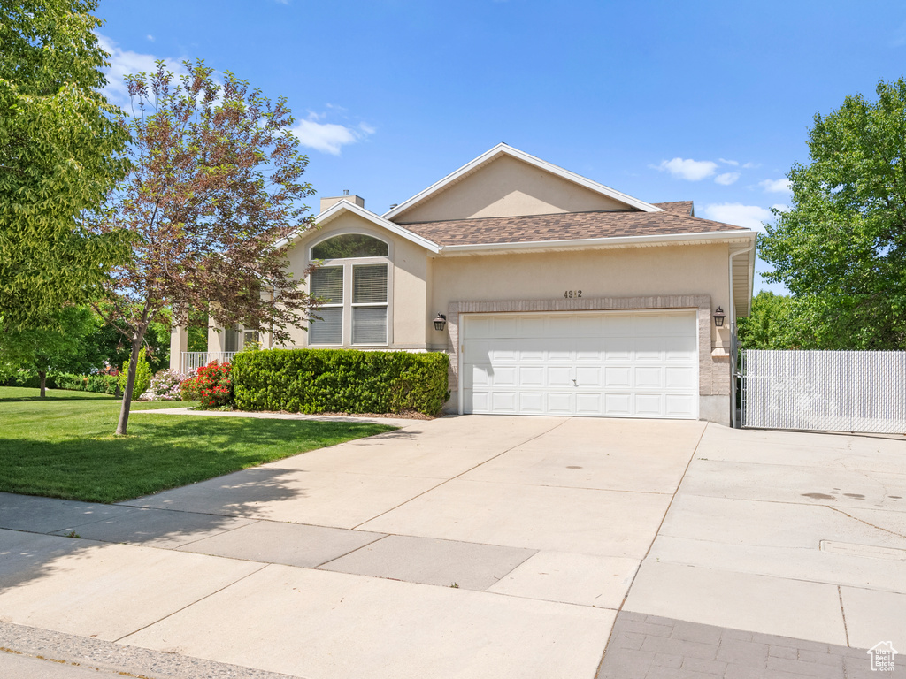 View of front of house featuring stucco siding, a garage, and concrete driveway