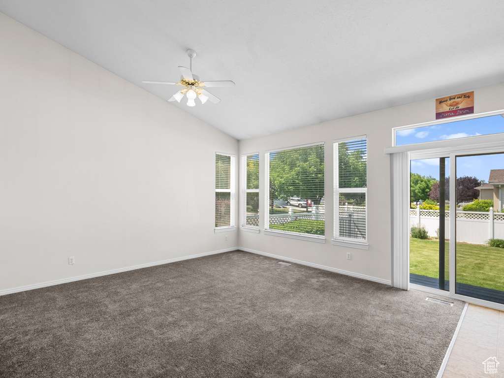 Unfurnished sunroom featuring vaulted ceiling