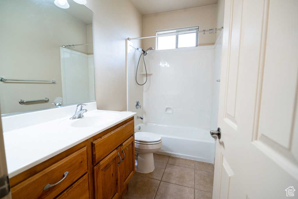 Full bathroom with vanity, toilet, shower / bathtub combination, and tile patterned flooring