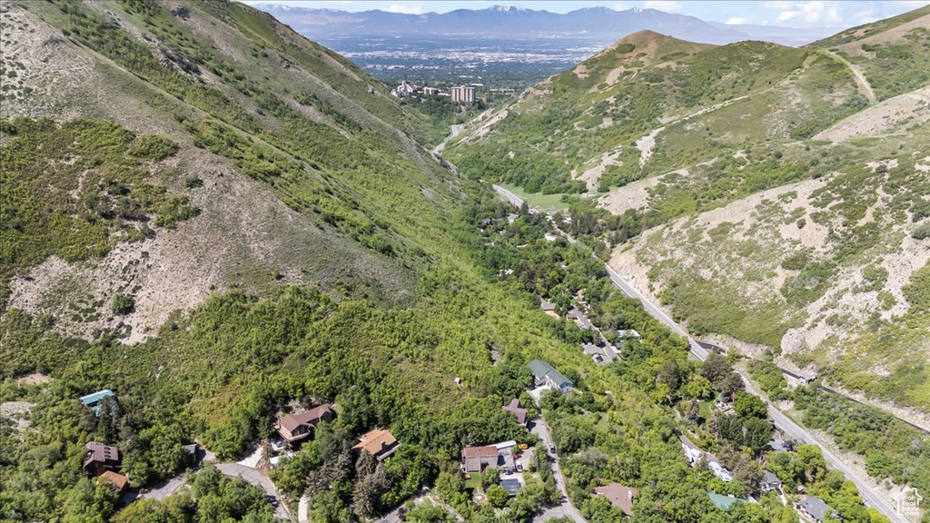 Aerial view of property and surrounding area with a mountainous background