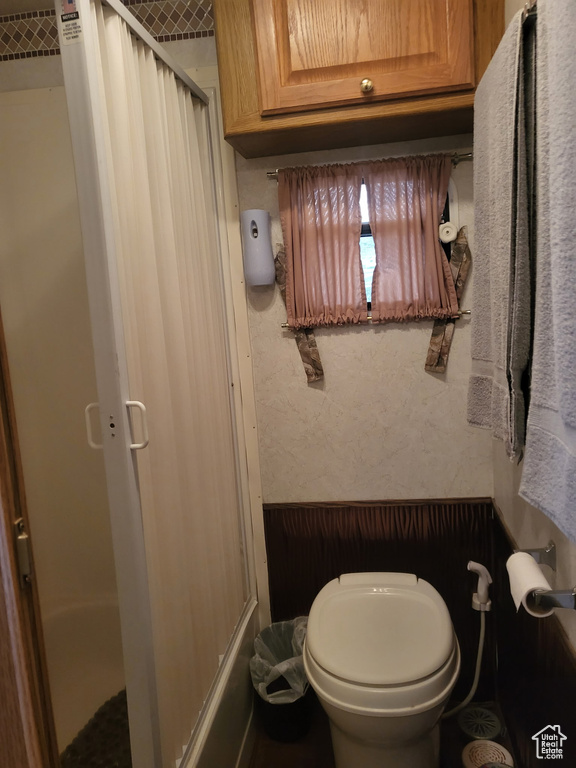 Full bath featuring an enclosed shower and toilet