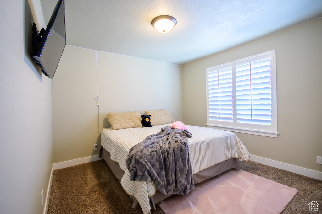 Carpeted bedroom with baseboards