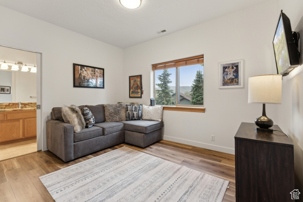 Living area with light wood-type flooring and baseboards