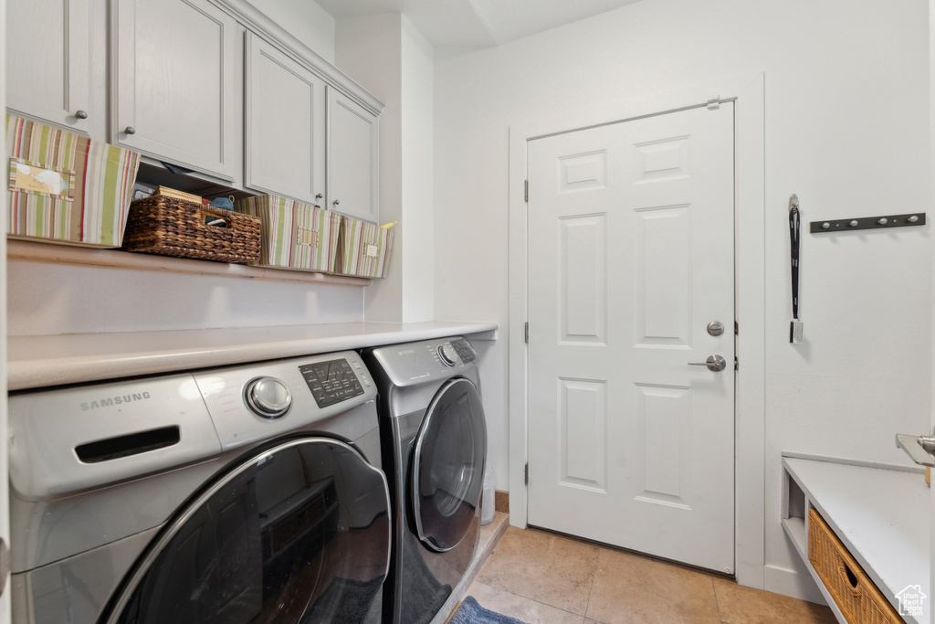 Washroom with washing machine and dryer and cabinet space