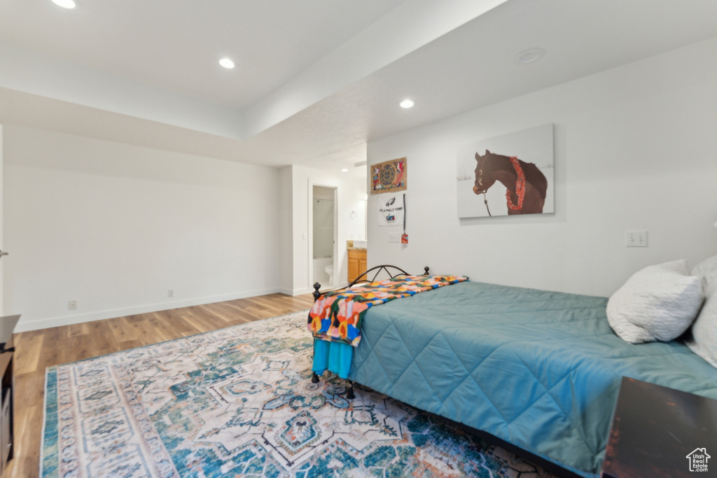 Bedroom featuring wood finished floors, baseboards, and recessed lighting