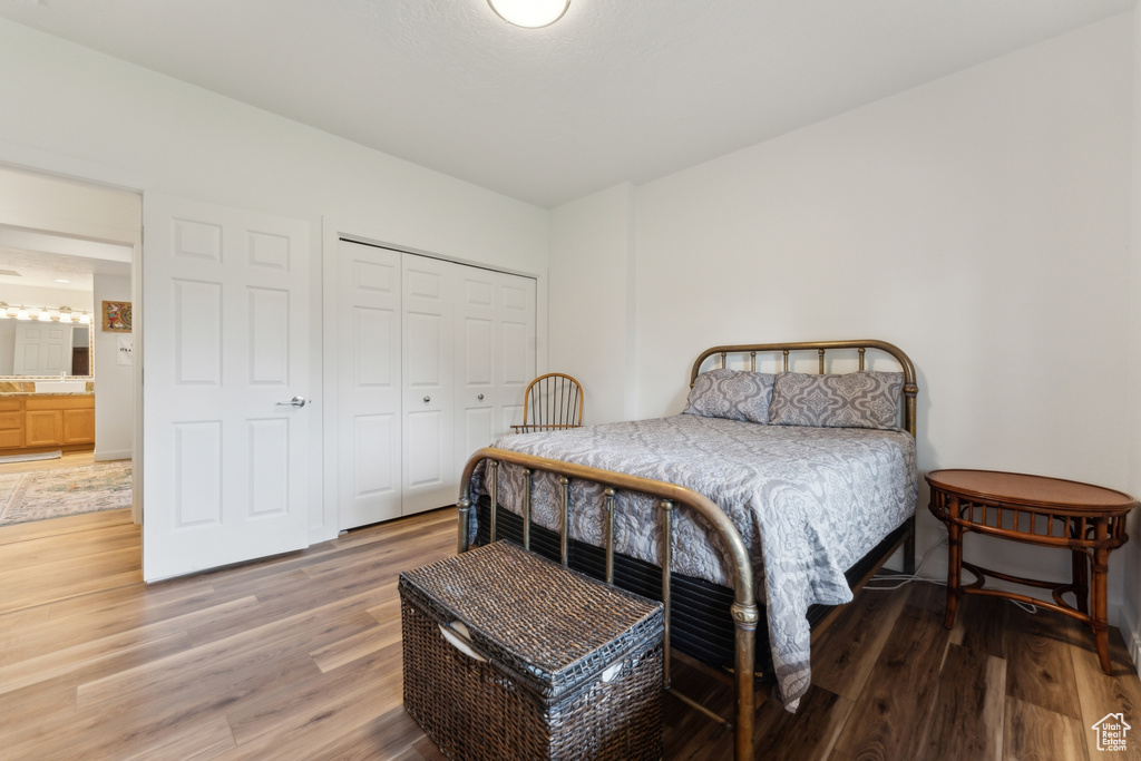 Bedroom featuring light wood-type flooring and a closet