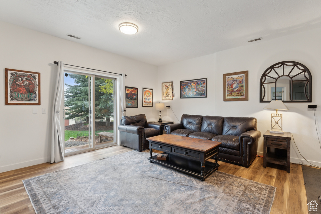 Living area with wood finished floors and baseboards