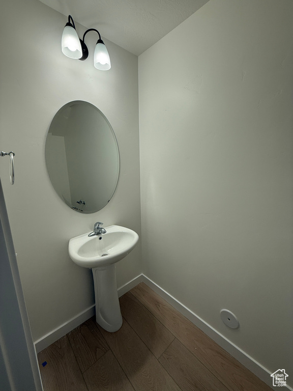 Bathroom featuring wood finished floors and baseboards