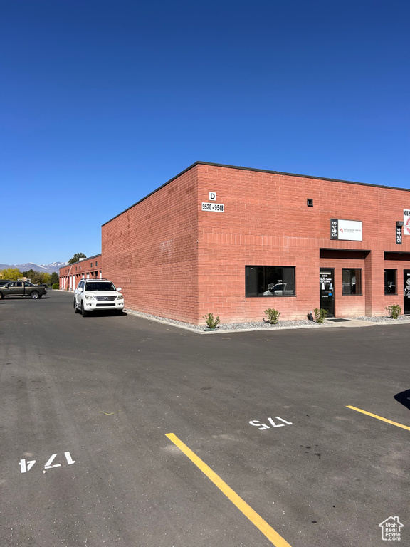 View of property with uncovered parking