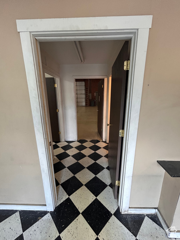 Hallway featuring tile patterned floors
