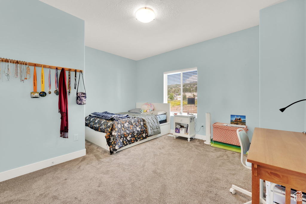 Bedroom featuring carpet flooring and baseboards