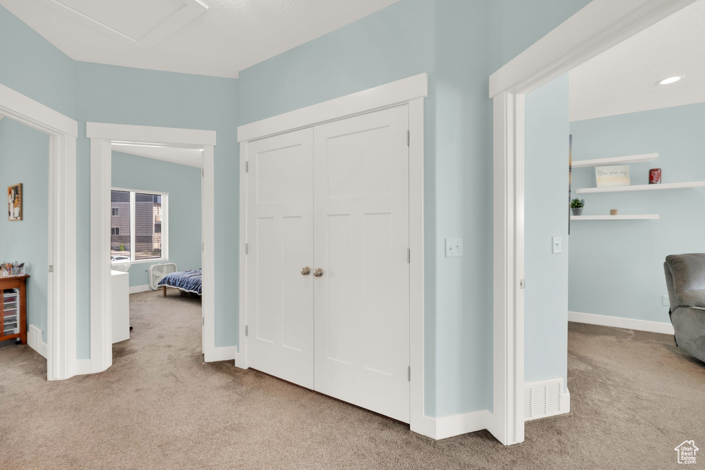 Hall featuring carpet floors and baseboards