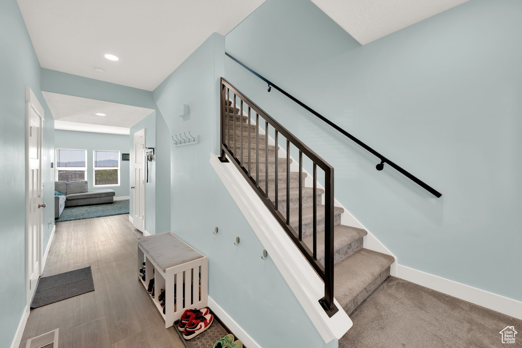Staircase featuring baseboards and recessed lighting