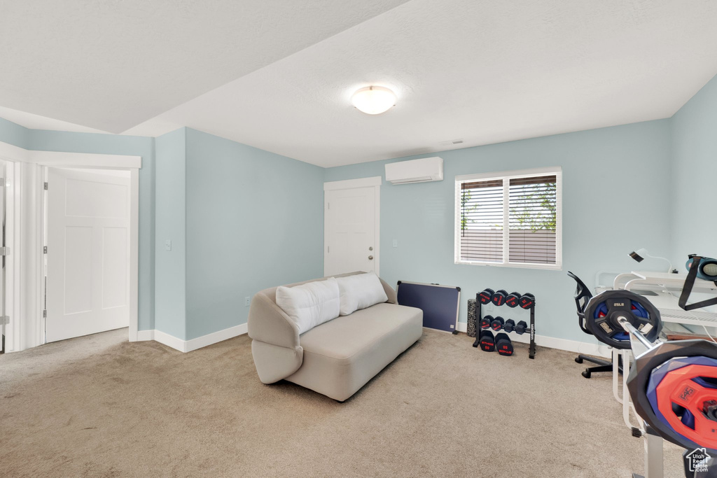 Carpeted office featuring a wall mounted AC and baseboards