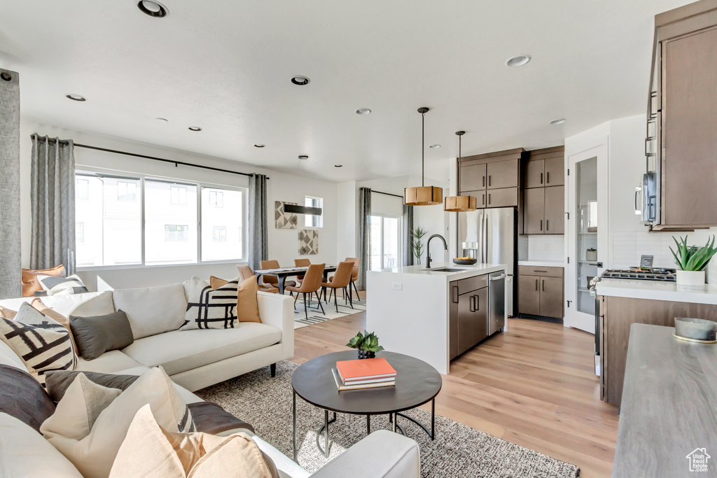 Living room featuring light wood-style flooring and recessed lighting