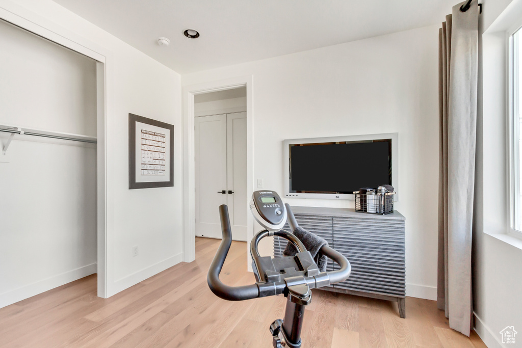 Exercise room featuring light wood-style floors and baseboards