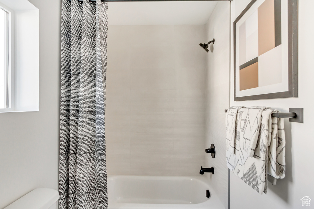 Full bathroom with shower / bath combo and toilet