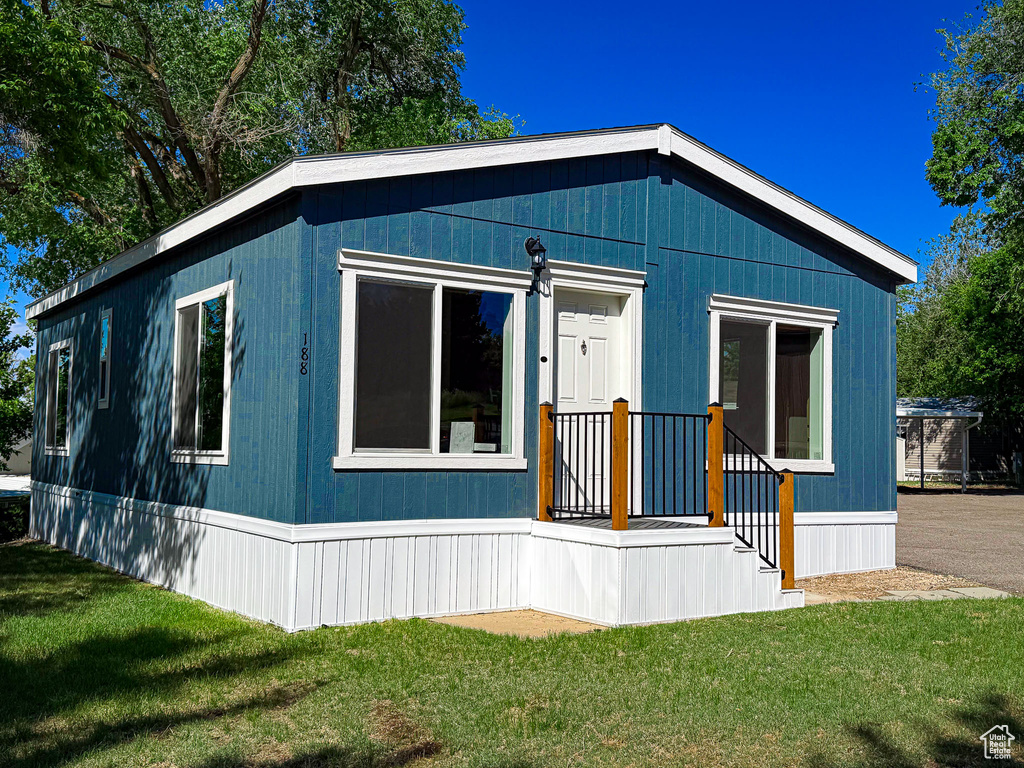 View of property exterior with a lawn