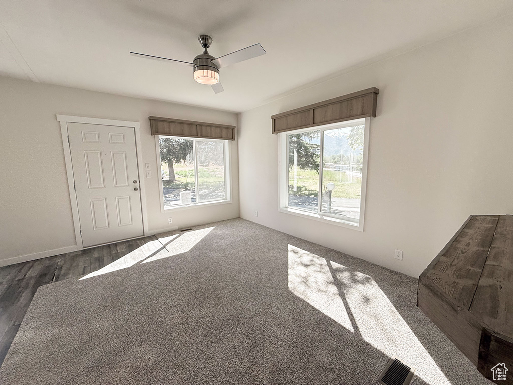Empty room featuring ceiling fan and wood finished floors