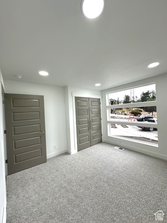Unfurnished bedroom with carpet flooring, recessed lighting, baseboards, and a closet