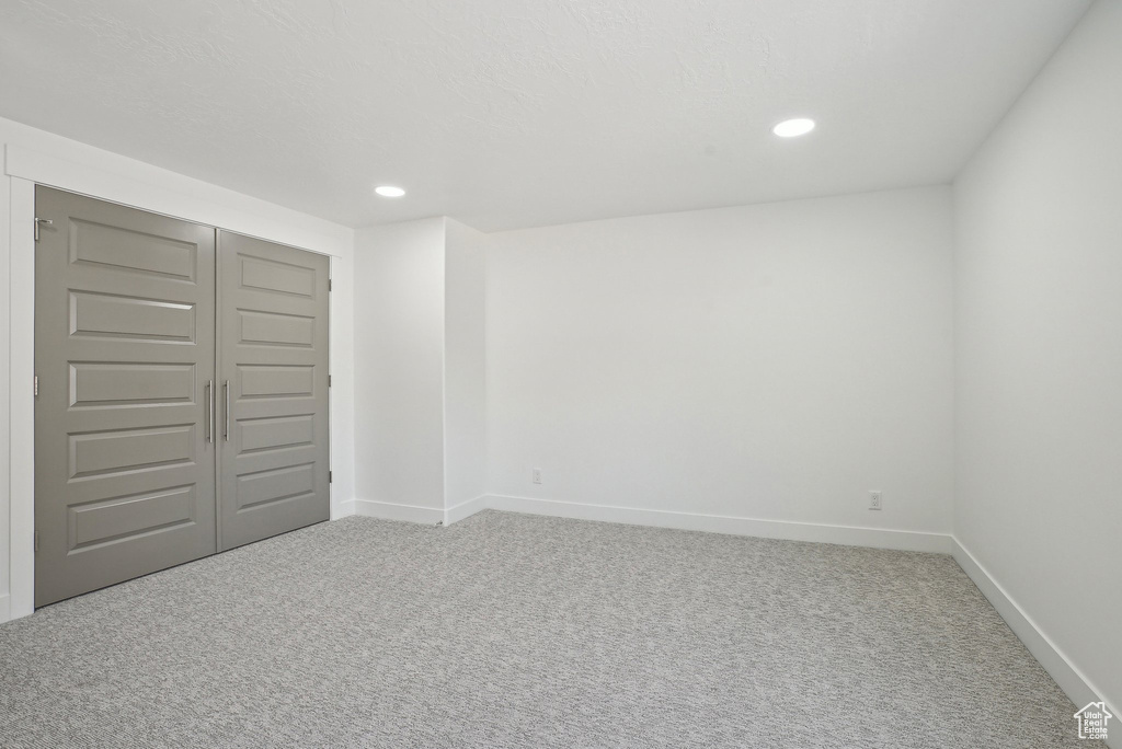 Unfurnished bedroom with carpet flooring, baseboards, recessed lighting, and a closet