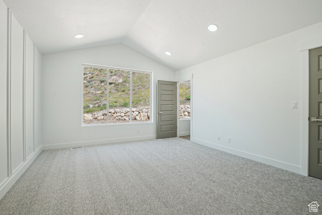 Unfurnished bedroom featuring vaulted ceiling, carpet flooring, baseboards, and recessed lighting