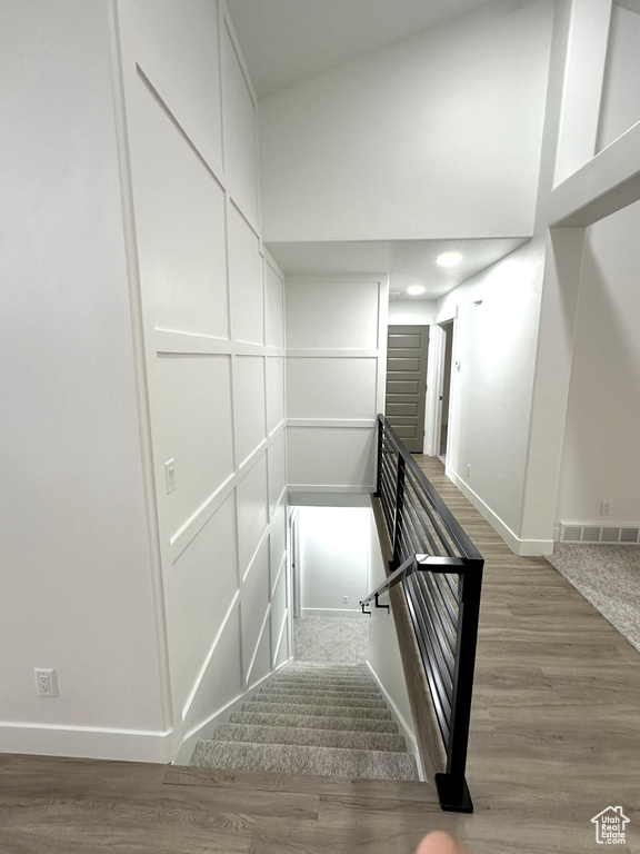 Stairway featuring baseboards and wood finished floors
