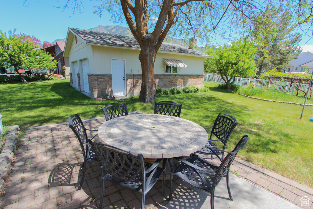 View of patio / terrace with outdoor dining space and a detached garage