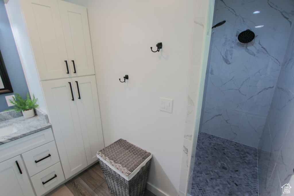Mudroom featuring wood finished floors and a sink