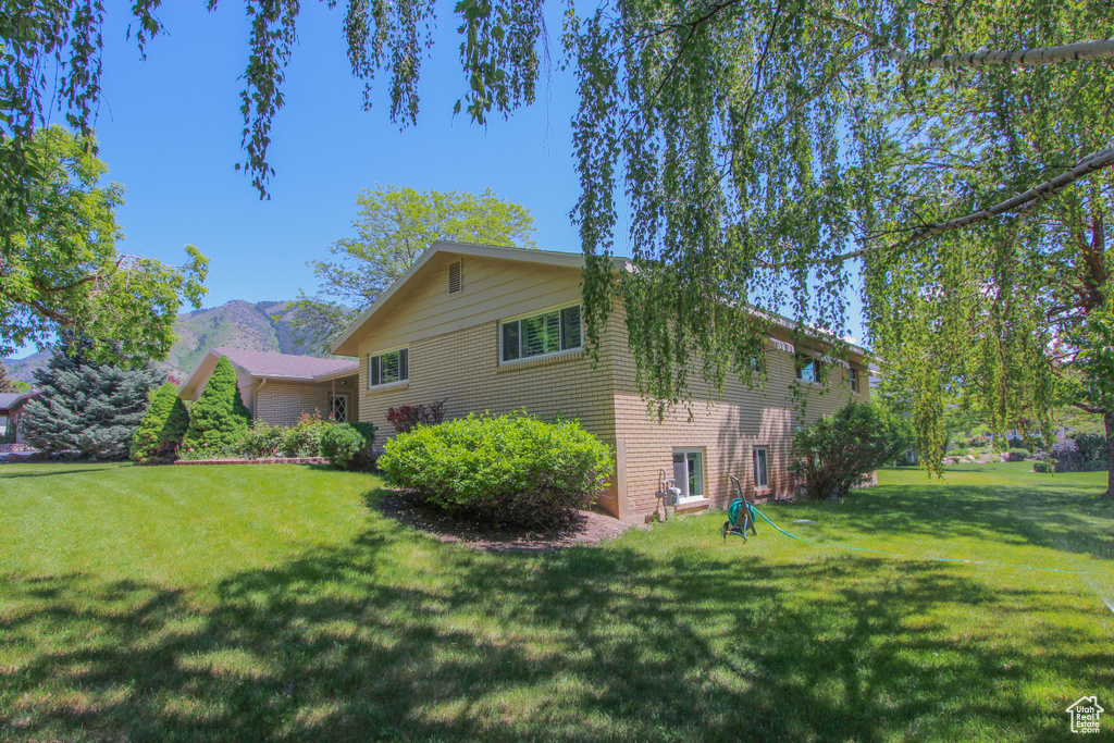 View of home's exterior with a lawn