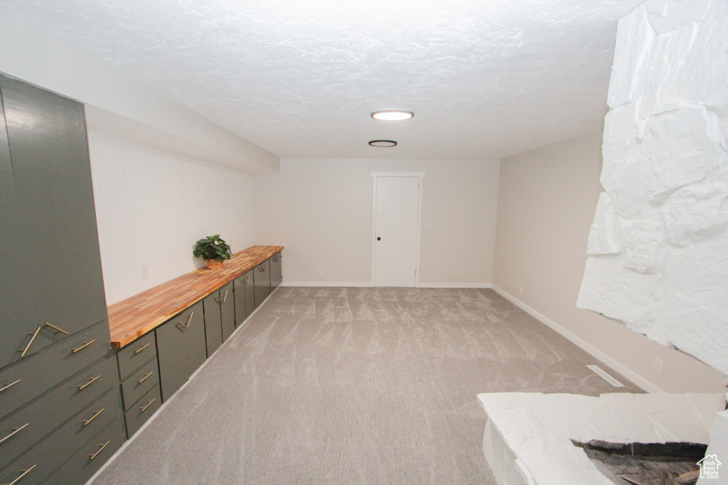 Hall featuring light carpet, baseboards, and recessed lighting