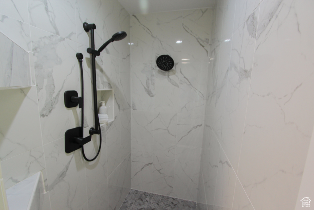 Bathroom featuring a marble finish shower