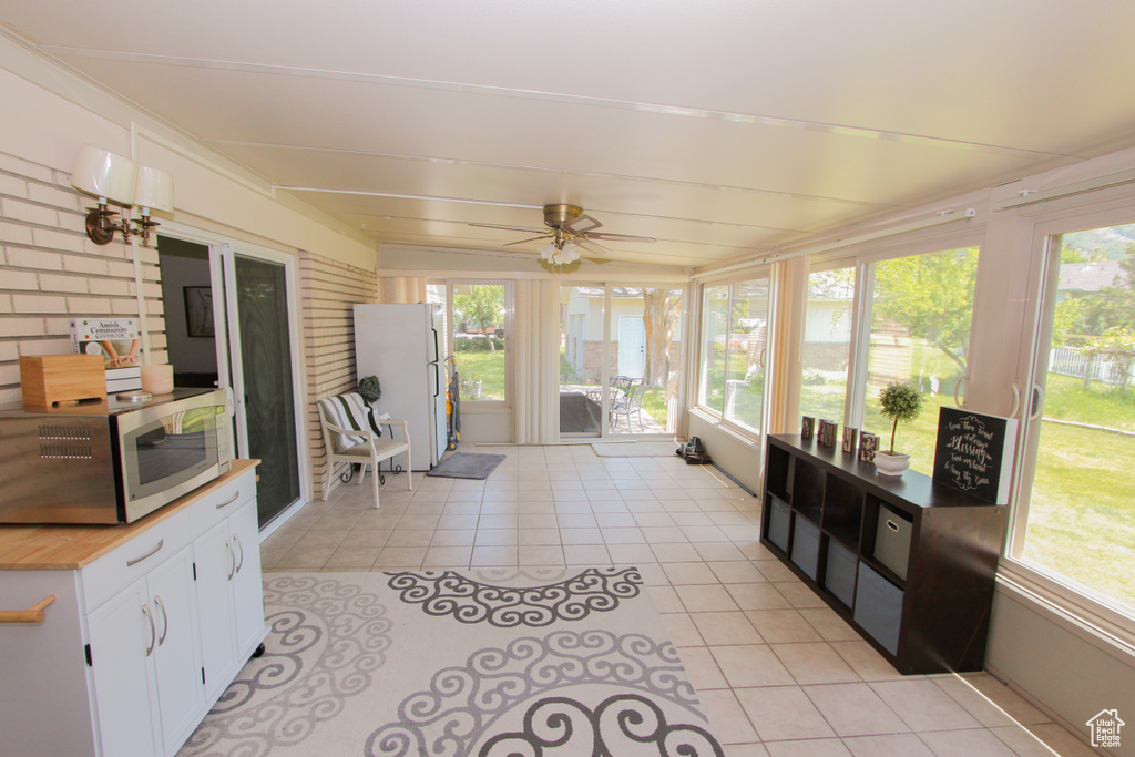Sunroom / solarium with tile patterned flooring and plenty of natural light