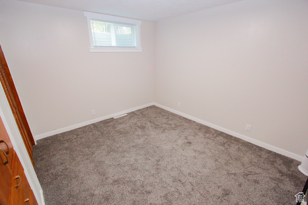 Below grade area with carpet flooring and baseboards
