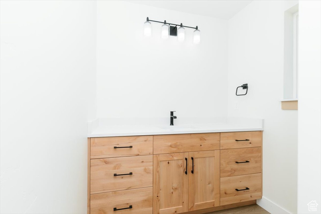 Bathroom featuring vanity and baseboards