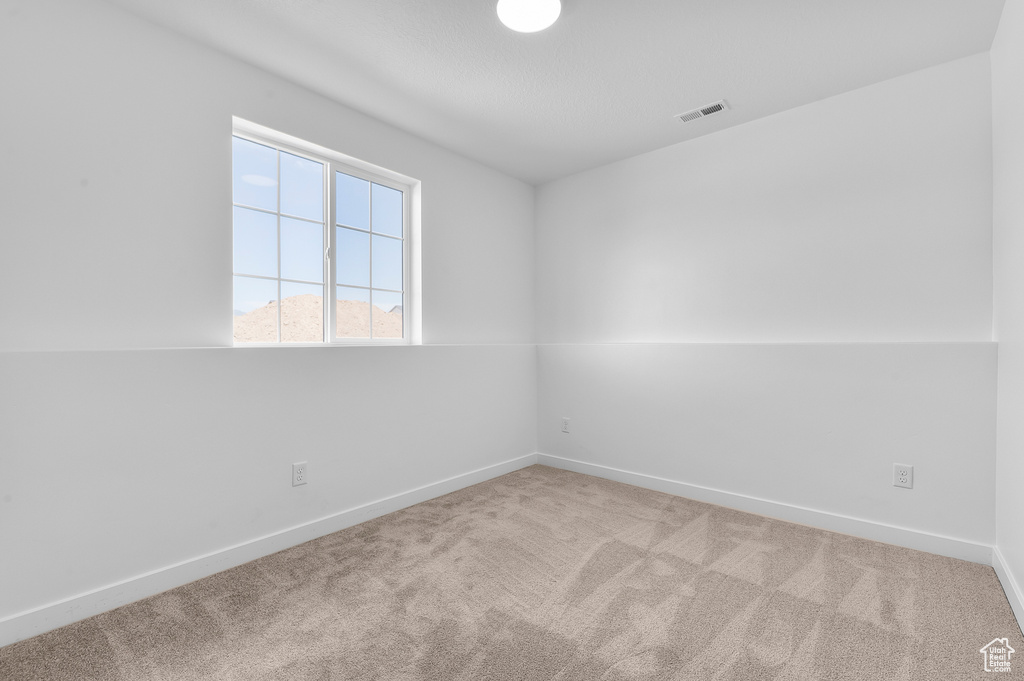 Empty room with carpet floors and baseboards