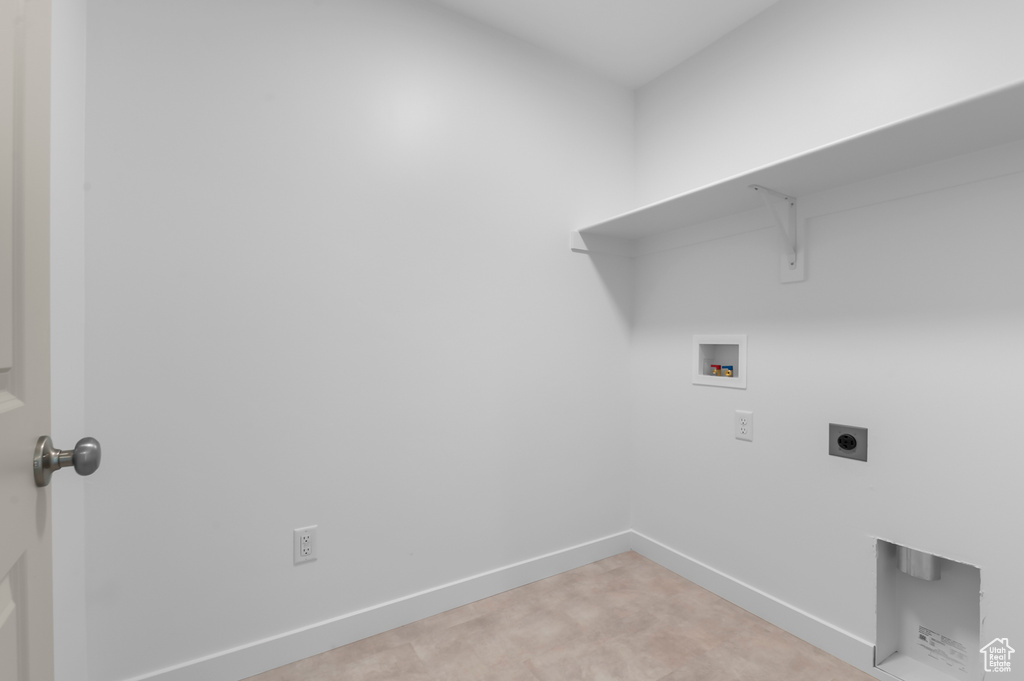 Laundry area featuring hookup for a washing machine, electric dryer hookup, and baseboards
